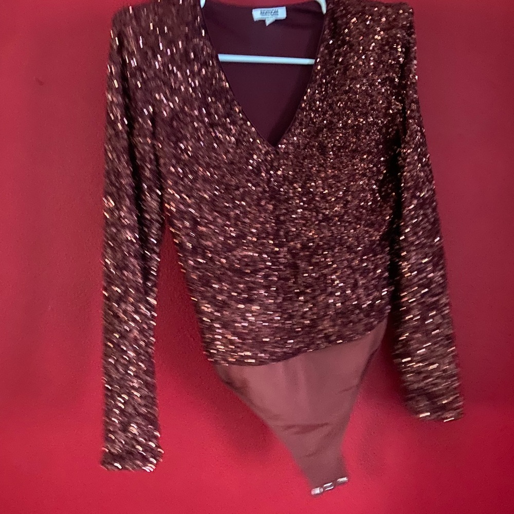 Red wine color sparkling bodysuit!! Perfect for a night out. has shoulder pads!